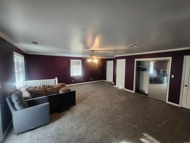 living room featuring carpet, ceiling fan, and ornamental molding