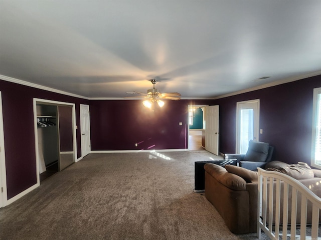 carpeted living room featuring ceiling fan and crown molding