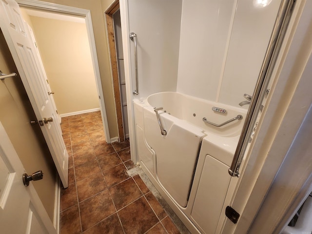 bathroom with tile patterned floors and a bathing tub