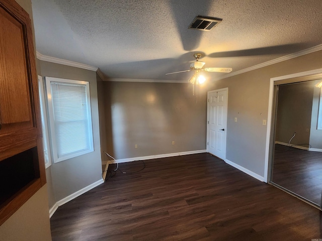 unfurnished bedroom featuring ceiling fan, dark hardwood / wood-style floors, and a textured ceiling