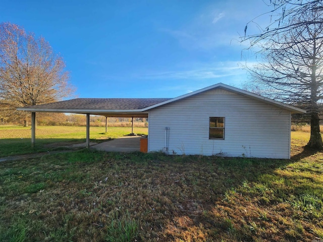 view of property exterior featuring a yard and a carport