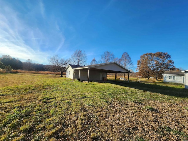 view of yard with a rural view and a carport