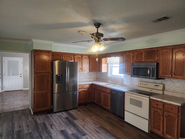 kitchen with dark hardwood / wood-style flooring, ornamental molding, stainless steel appliances, ceiling fan, and sink