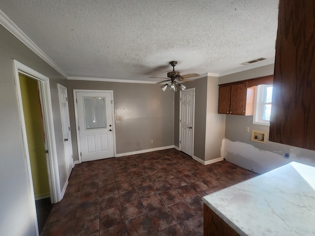 kitchen with ceiling fan, crown molding, and a textured ceiling