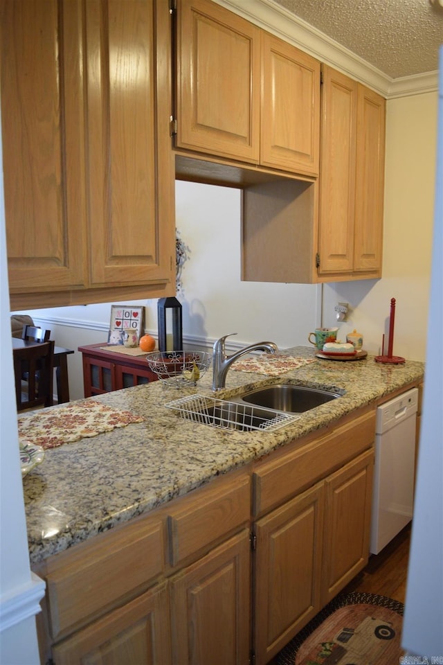 kitchen featuring sink, light stone counters, crown molding, white dishwasher, and a textured ceiling