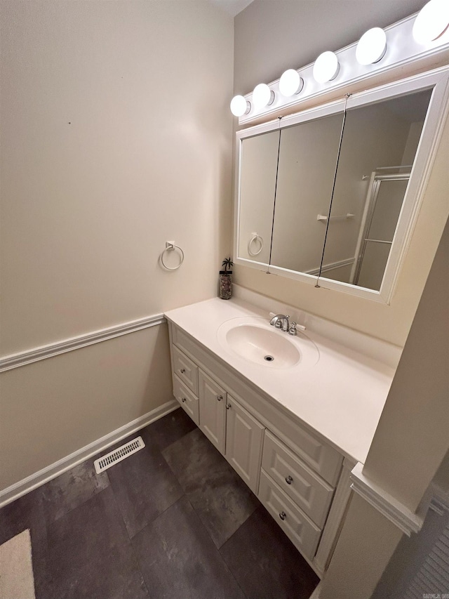 bathroom featuring vanity and a shower with shower door