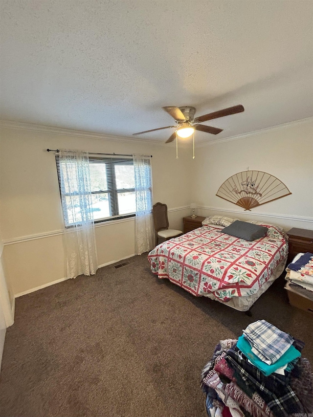 bedroom with ceiling fan, crown molding, a textured ceiling, and dark colored carpet