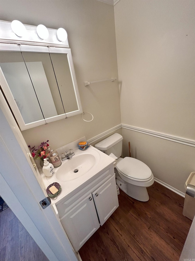 bathroom featuring vanity, wood-type flooring, and toilet