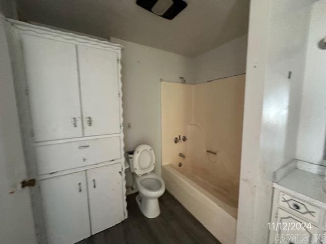 bathroom featuring hardwood / wood-style floors, toilet, and shower / bathing tub combination