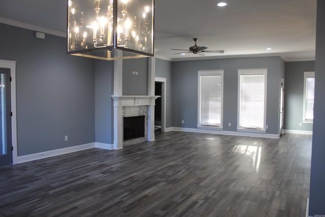 unfurnished living room with a fireplace, dark wood-type flooring, and crown molding