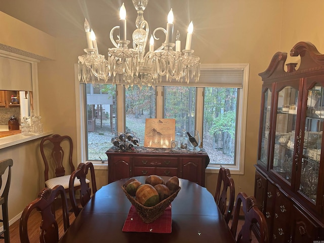 dining room featuring hardwood / wood-style floors and an inviting chandelier