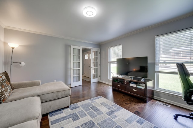 living room with dark hardwood / wood-style flooring, crown molding, and french doors