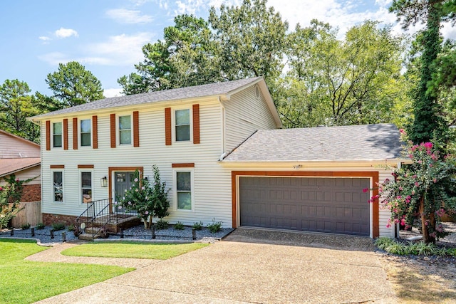 colonial-style house featuring a garage and a front lawn