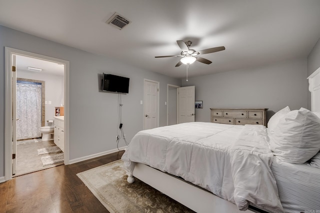 bedroom with connected bathroom, ceiling fan, and dark wood-type flooring