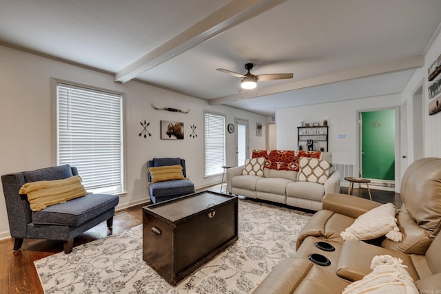 living room with hardwood / wood-style flooring, ceiling fan, a healthy amount of sunlight, and beam ceiling