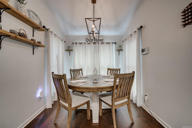 dining room featuring dark hardwood / wood-style flooring and vaulted ceiling