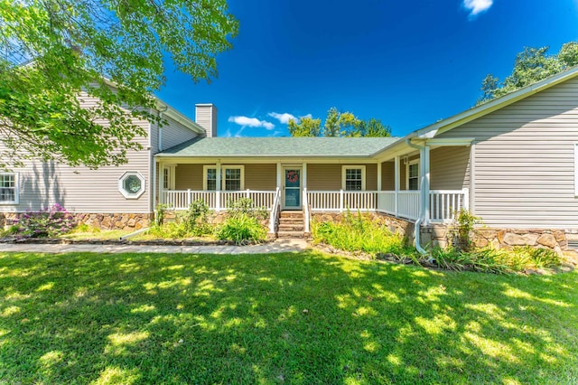 view of front of property with covered porch and a front yard