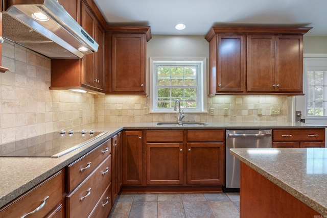 kitchen featuring sink, black electric cooktop, plenty of natural light, and range hood