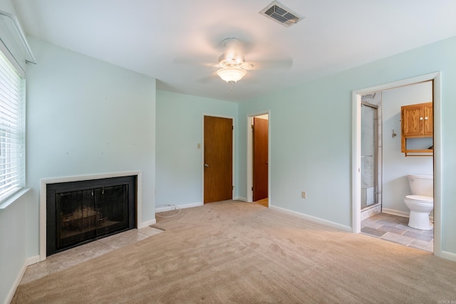 unfurnished living room featuring ceiling fan and light colored carpet