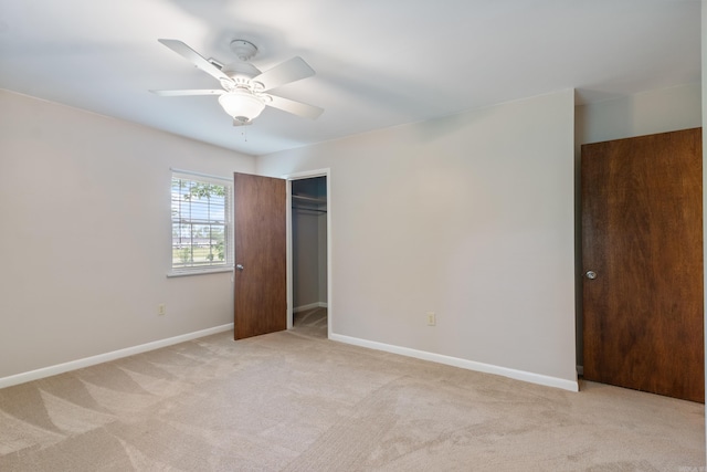 unfurnished bedroom with ceiling fan, a closet, and light colored carpet