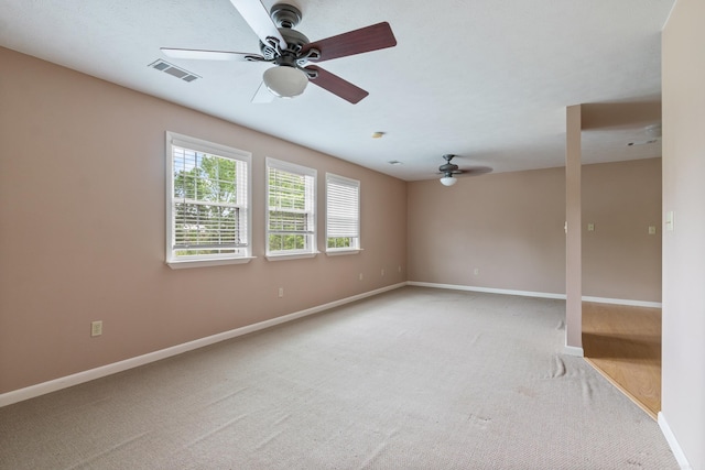 empty room with ceiling fan and carpet floors