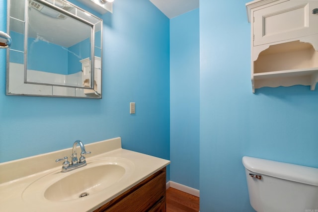 bathroom featuring hardwood / wood-style floors, vanity, and toilet