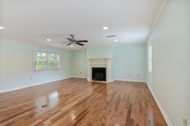 unfurnished living room with ceiling fan, light wood-type flooring, and crown molding