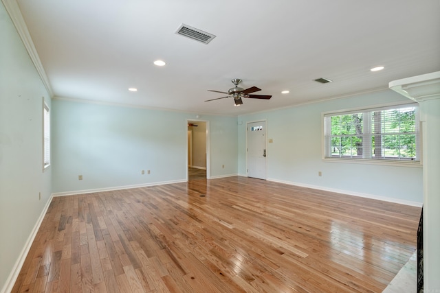 spare room with light hardwood / wood-style floors, ceiling fan, and ornamental molding