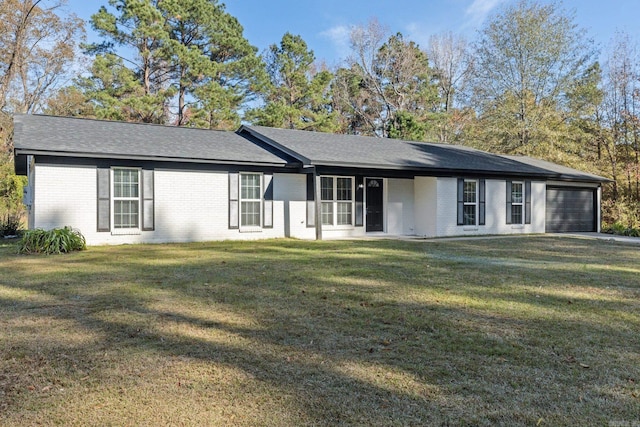 view of front of home featuring a garage and a front lawn