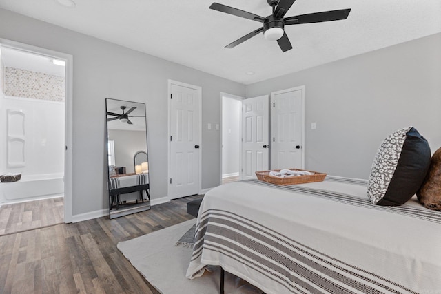 bedroom featuring ensuite bathroom, ceiling fan, and dark wood-type flooring