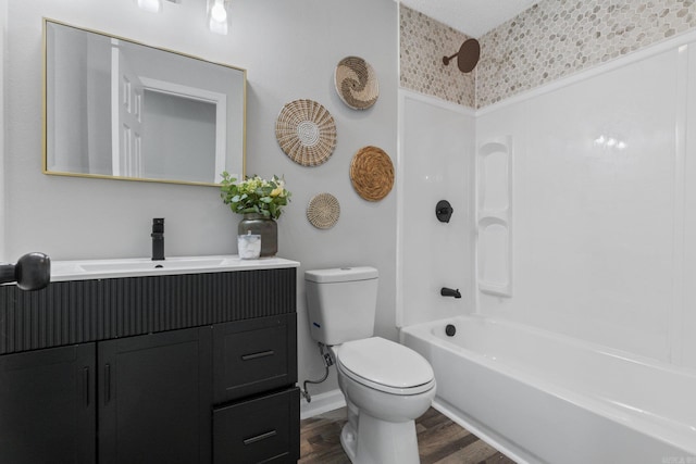 full bathroom featuring shower / washtub combination, vanity, wood-type flooring, and toilet