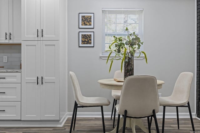 dining area featuring dark wood-type flooring