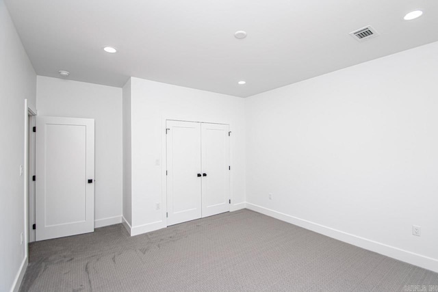 unfurnished bedroom with carpet floors and a closet