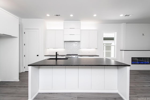 kitchen featuring dark hardwood / wood-style floors, white cabinetry, and sink