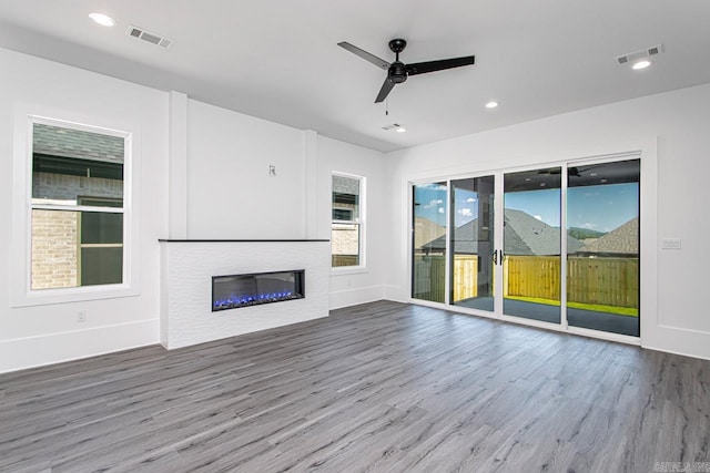 unfurnished living room featuring ceiling fan and wood-type flooring