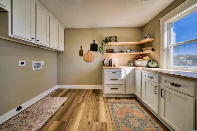 laundry area with hookup for a washing machine, light hardwood / wood-style flooring, cabinets, and hookup for an electric dryer