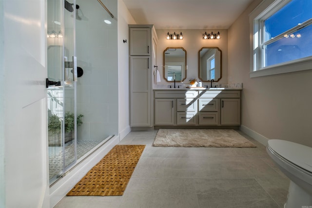 bathroom with tile patterned floors, vanity, toilet, and an enclosed shower