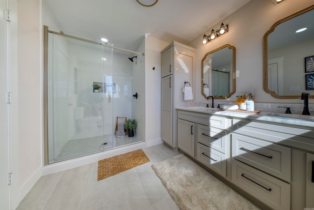 bathroom with tile patterned floors, vanity, and walk in shower