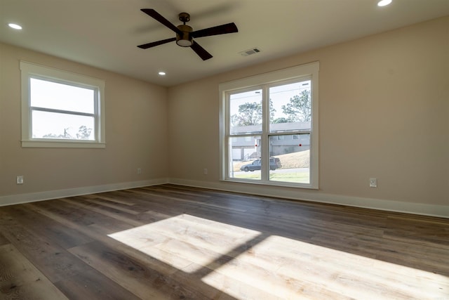 spare room with ceiling fan and dark wood-type flooring