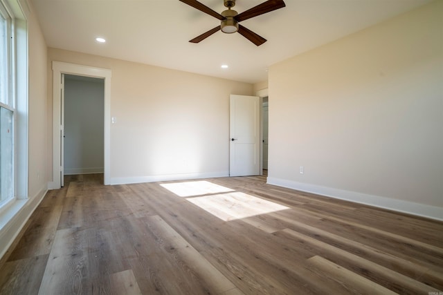 empty room featuring wood-type flooring and ceiling fan