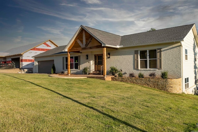 view of front of house with a front yard and a garage