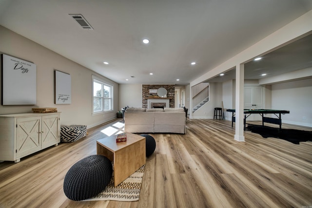 living room featuring a fireplace and light hardwood / wood-style flooring