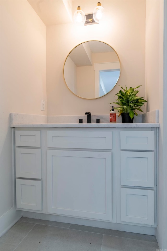 bathroom featuring tile patterned flooring and vanity