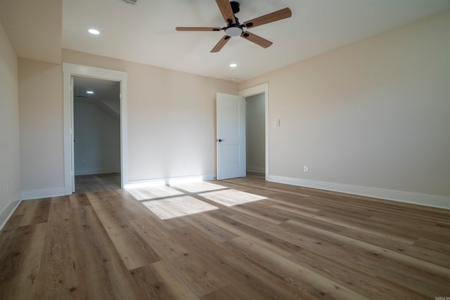 empty room with light wood-type flooring and ceiling fan