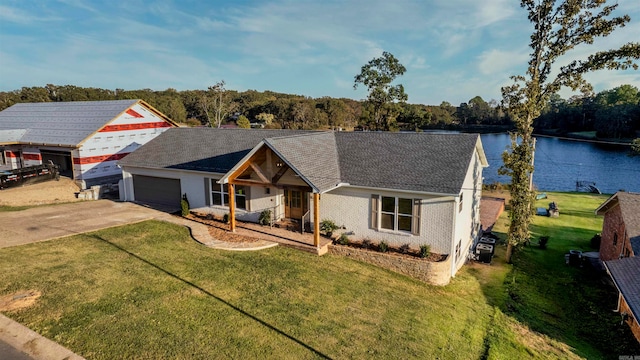 ranch-style house with a water view, a garage, and a front lawn