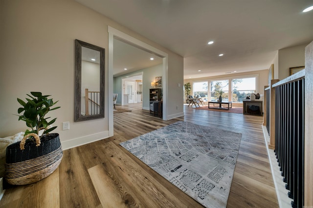 hallway with hardwood / wood-style flooring