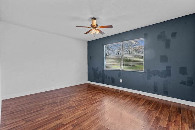 spare room featuring hardwood / wood-style floors, ceiling fan, and a textured ceiling