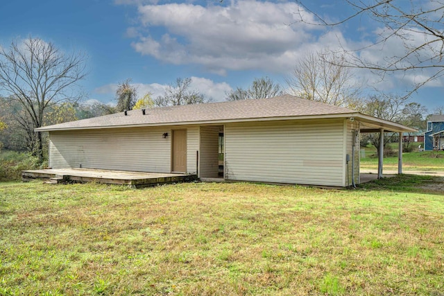 back of property with a yard and a wooden deck