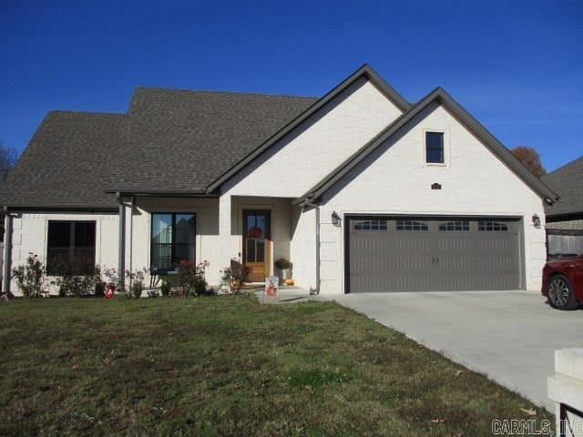 view of front facade with a garage and a front lawn