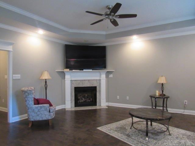 living room featuring hardwood / wood-style flooring, ceiling fan, and crown molding